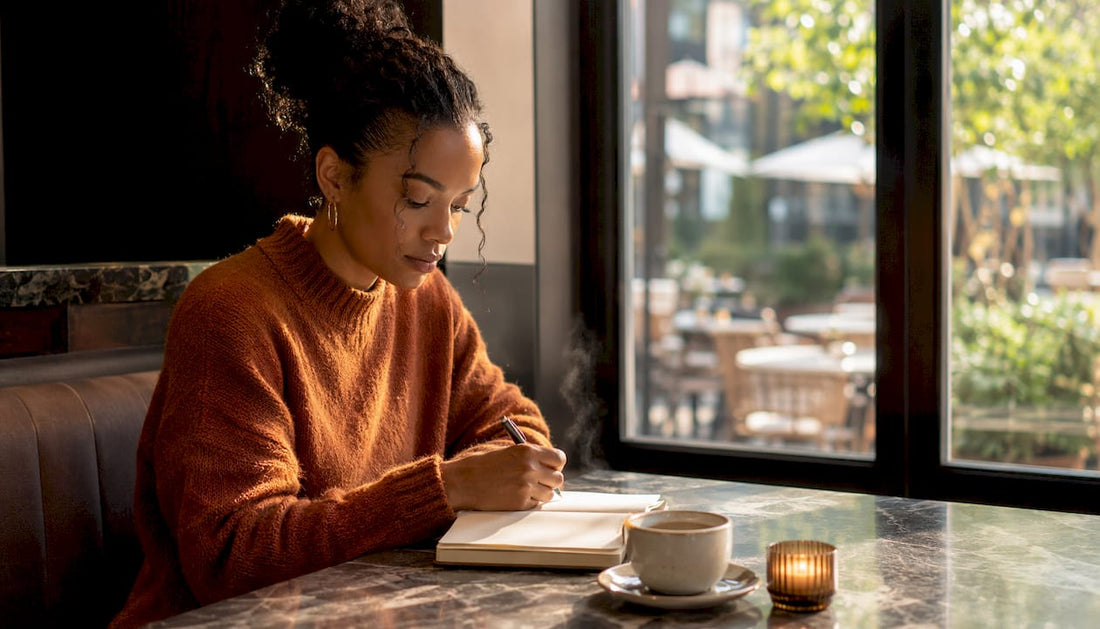 Woman journaling daily confidence practices at home