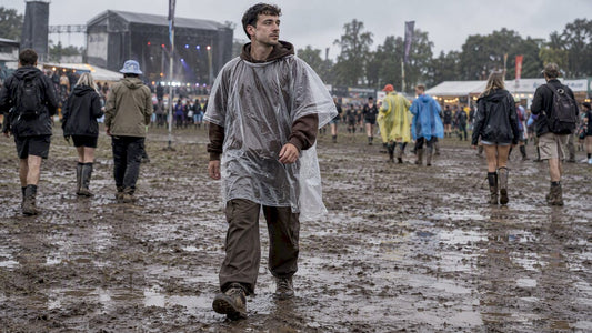 Festival attendee wearing streetwear under a clear poncho