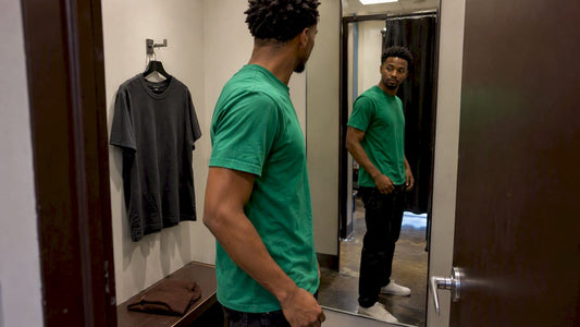 Man comparing streetwear colors in a fitting room