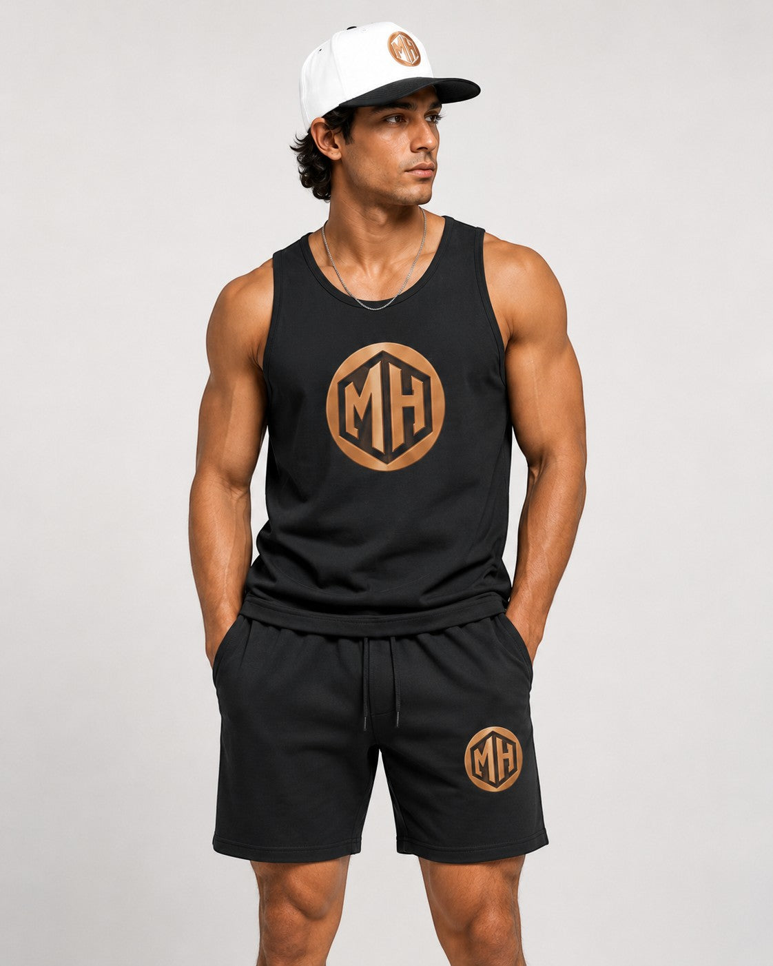 MR. HAPPINESS black oversized muscle tank with gold MH logo on chest, made of 100% cotton.